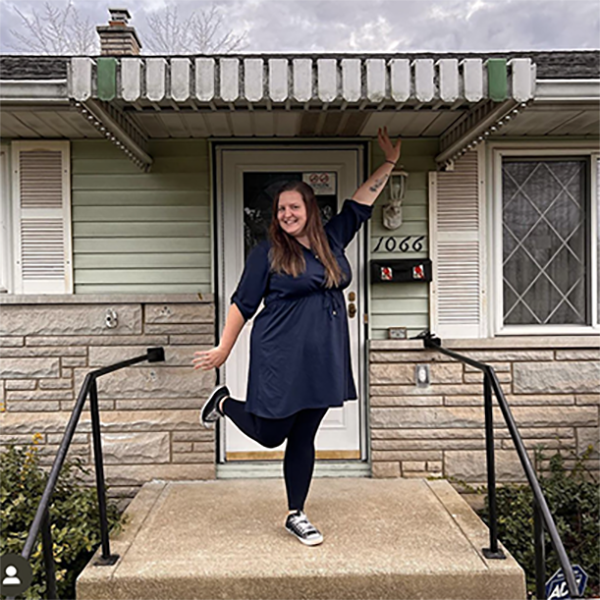 Home buyer in front of her fixer-upper